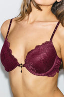 Burgundy lace push-up bra with front charm and rhinestone-studded straps, front view on model