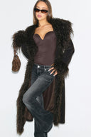 Dark brown faux fur figure-hugging full-length coat with shaggy collar and cuffs, front view on model