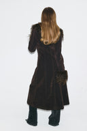 Dark brown faux fur figure-hugging full-length coat with shaggy cuffs and seamed back, back view on model