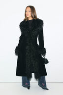 Black faux fur figure-hugging full-length coat with shaggy collar and cuffs, front view on model