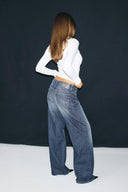 Dark blue loose-fit jeans with low waist and wide legs, back view on model