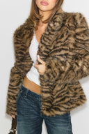Tiger print faux fur shaped jacket with long sleeves, worn open, front view on model