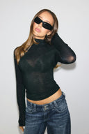 Black sheer tight-fit turtleneck top with long sleeves, front view on model