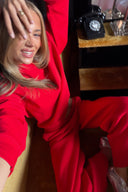 Red baggy crew neck sweater, styled with matching red sweatpants, selfie in a hotel room