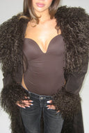 Dark brown figure-hugging bodysuit with padded push-up cups and deep neckline, styled with a brown faux fur coat