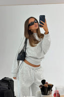 Grey melange oversized crew neck sweater with long sleeves, styled with matching sweatpants in a mirror selfie