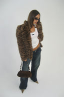 Tiger print faux fur shaped jacket with long sleeves, styled with a white tank top in a photo studio