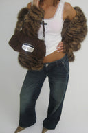 Vintage blue loose-fit low-waist wide-leg baggy jeans, styled with a tiger print faux fur jacket and white tank top
